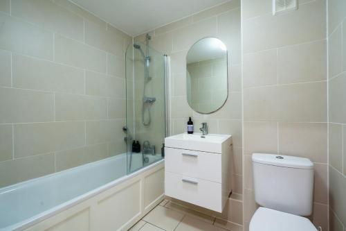 a bathroom with a toilet and a shower and a sink at Ascot Racecourse Apartment in Ascot
