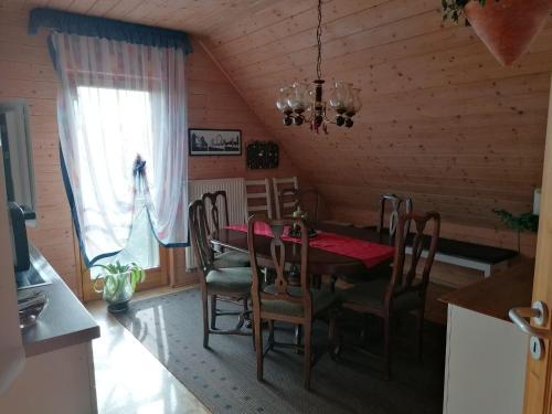 a dining room with a table and chairs and a window at Ferienhaus Nebenan Plus in Ebern