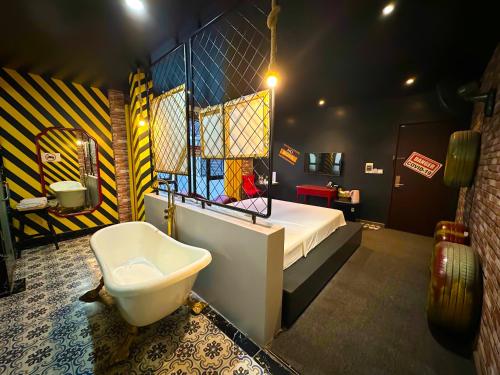 a bedroom with a bed and a toilet in it at Zenshunga Hotel Yên Hoà- Hà Nội in Hanoi