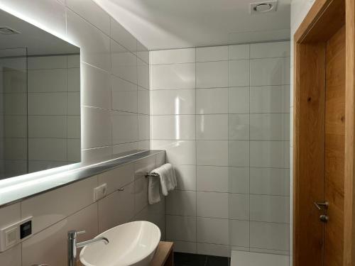 a bathroom with a sink and a mirror at Lieblingsplatz Alpine Lodge in Tschagguns