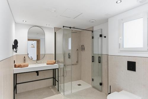 a bathroom with a sink and a shower at Aquasol Aparthotel in Palmanova