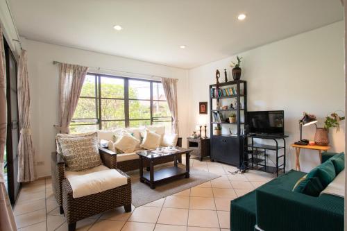 a living room with a couch and a tv at Garden Villa in Bali Residence Mae Phim with Kids Bunk Suite in Ban Bua Phut