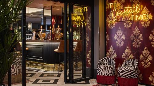 a restaurant with two chairs in front of a store at Solo Sokos Hotel Turun Seurahuone in Turku