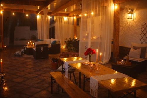 a room with two tables and a living room with candles at A Encantada Spa e Vista 180 Casa de Artista in Alqueve