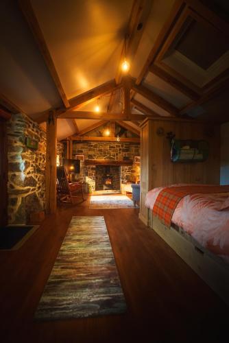 a bedroom with a bed and a fireplace at Mullach Dearg in Tarbert