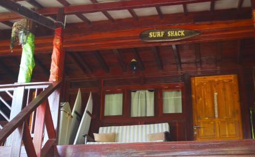 a wooden cabin with a sign that reads surf shack at Lakey Peak Haven in Huu