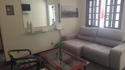 a living room with a couch and a table at Pousada Icaraí Inn in Niterói