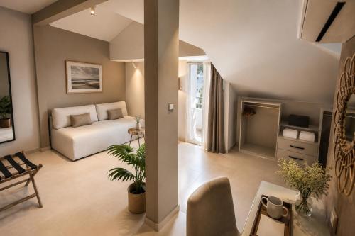 a living room with a bed and a table at ELLE Rooms & Suites in Paralia Katerinis