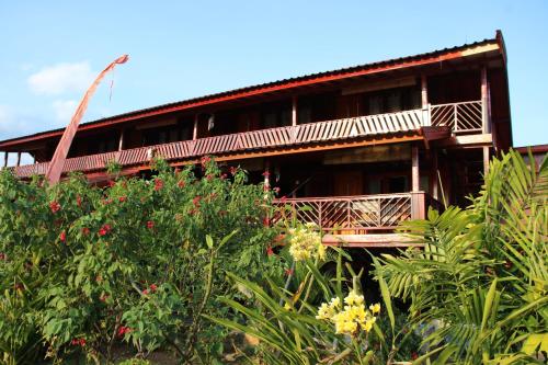 a building with a balcony in the middle of plants at Lakey Peak Haven in Huu