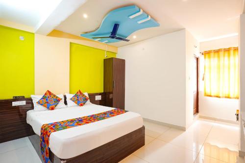 a bedroom with a bed and a blue ceiling at FabHotel Saanidhya Comforts - Tumkur Road in Kunigal