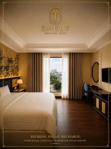 Llit o llits en una habitació de Emely Hotel