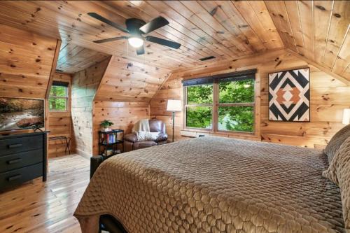 a bedroom with a bed and a ceiling fan at Awesome Adventures By Avada Properties in Sevierville
