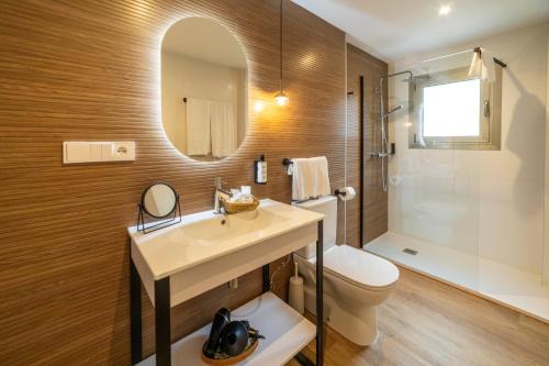 a bathroom with a sink and a toilet and a mirror at Petit Garden Hotel by Flacalco in Cala Ratjada