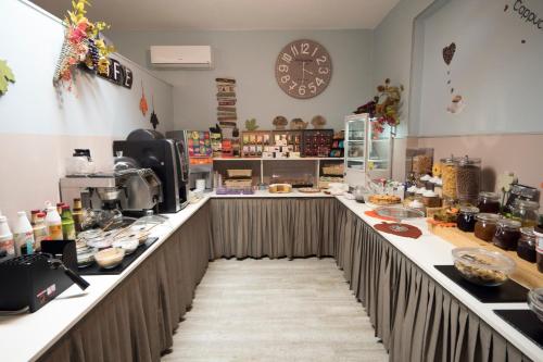 a kitchen with a long counter in a room at Albergo Serena in Lerici