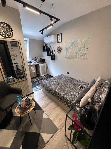 a bedroom with a bed and a couch and a table at Stayhome in Ruse