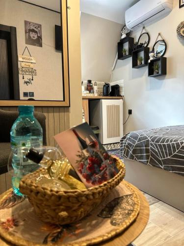 a table with a bowl with a book and a bottle at Stayhome in Ruse