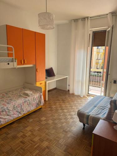 a bedroom with a bed and a desk and a window at Via degli Dei house in Sasso Marconi