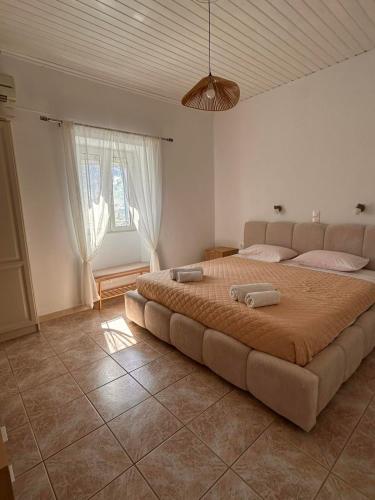 a bedroom with a large bed in a room at Villa Delphini in Argyrátika