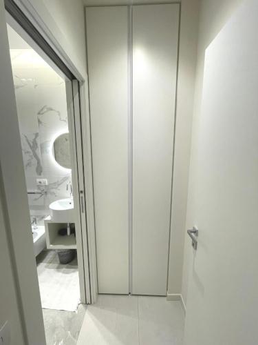 a bathroom with a toilet and a glass door at Appartamenti Angelo e Maria in Lovere
