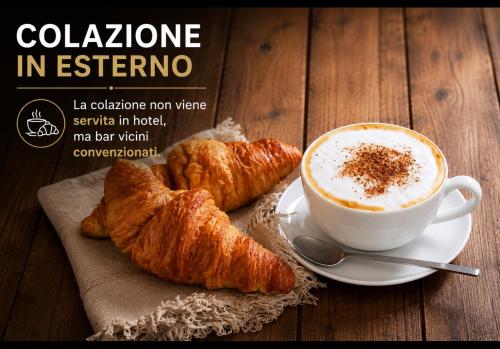 a cup of coffee and croissants on a table at Panhouse Rooms & Suite in Palermo