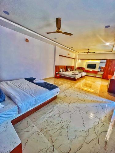 a bedroom with a bed and a ceiling fan at Geetanjali hotel and resort in Udaipur