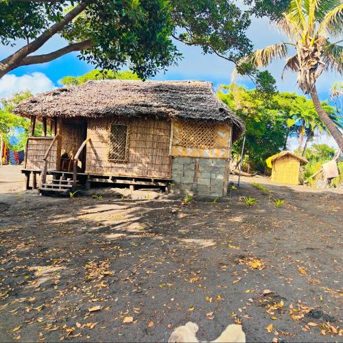 an old house with a straw roof on a dirt road at Montanna bungalow in Lénakel