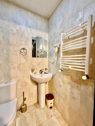 a bathroom with a sink and a toilet at Hotel Vera View in Tbilisi City