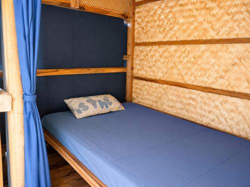 a small bed with a pillow in a room at Cactos Floating House Experience on Island in Lai Sơn