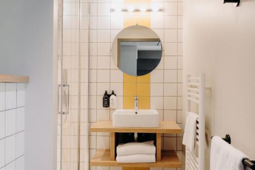 a bathroom with a sink and a mirror at PlanB Hotel - Living Chamonix in Chamonix