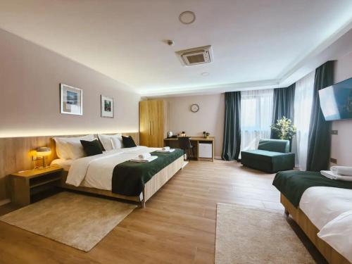 a hotel room with two beds and a chair at Tiona in Nova Gradiška