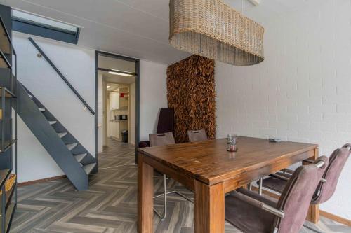 a dining room with a wooden table and chairs at Bungalowpark Herkingen 1B in Herkingen