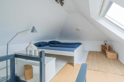 a room with a bed and a desk and a window at Bungalowpark Herkingen 1B in Herkingen