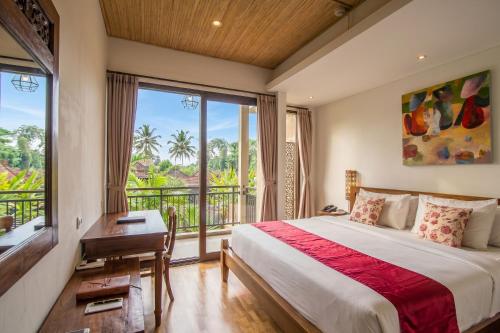 a bedroom with a bed and a balcony at Kamajaya Villas in Ubud