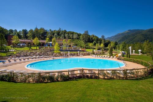 a large swimming pool in a yard with chairs at Podere La Torre in Schio