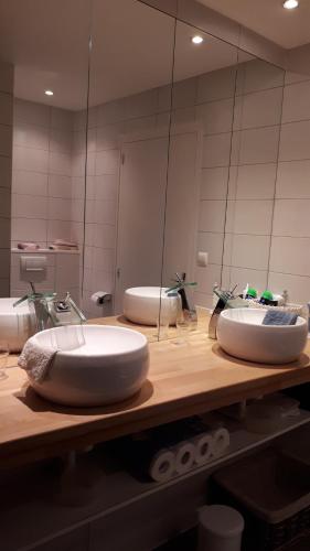 a bathroom with two sinks and a large mirror at Maison Lavande in Sousceyrac
