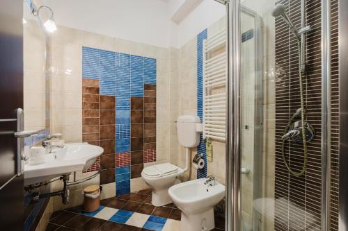 a bathroom with a toilet and a sink and a shower at Cerri Hotel in Castellammare del Golfo