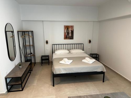 a bedroom with a bed with two towels on it at Lighthouse Rooms in Kriopigi