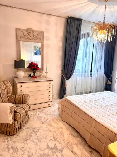 a bedroom with a bed and a dresser and a mirror at Villa Felicità in Lucca