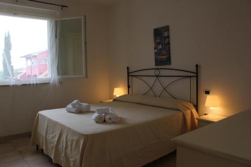 a bedroom with a bed with towels on it at Aba Village RTA in Puntone di Scarlino