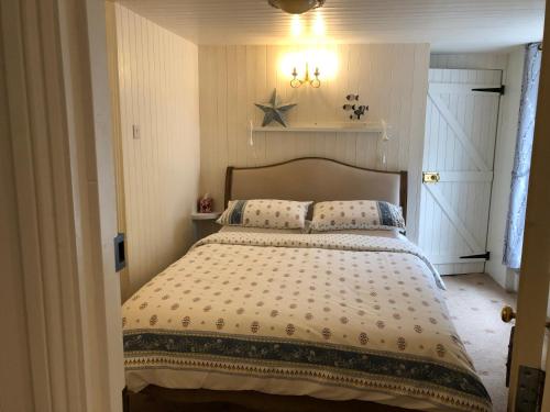 a bedroom with a large bed in a room at Samphire in Padstow