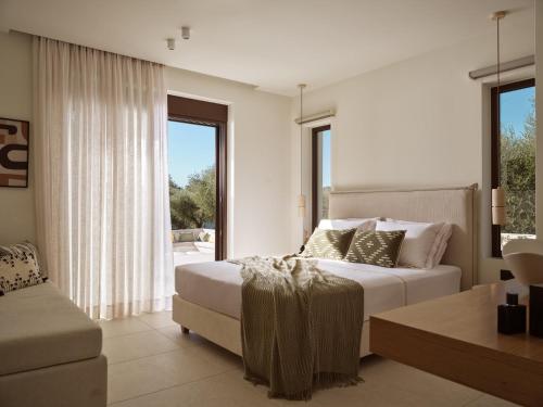 a bedroom with a bed and a large window at Alba d'Oro in Laganas