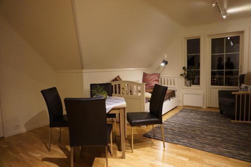 a living room with a table and chairs and a couch at Trasti & Trine Boutique Hotel in Alta
