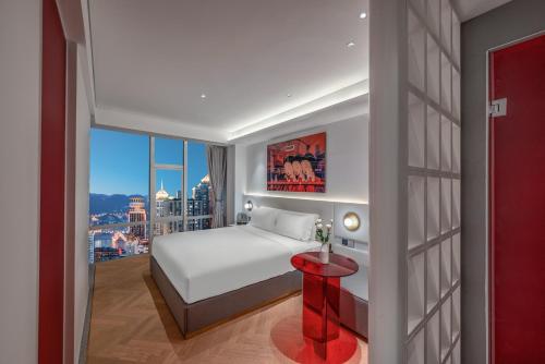 a bedroom with a bed and a view of a city at Aspera Star Essence Sky Garden Panoramic Hotel-Jiefangbei Hongya Branch in Chongqing