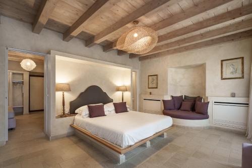 a large bedroom with a bed and a couch at Casa Vendicari Boutique Hotel in Noto
