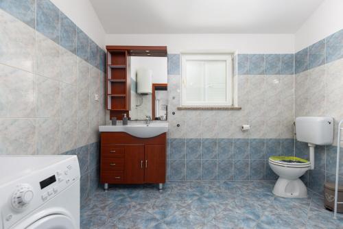 a bathroom with a toilet and a sink at Apartman Mely in Nova Vas