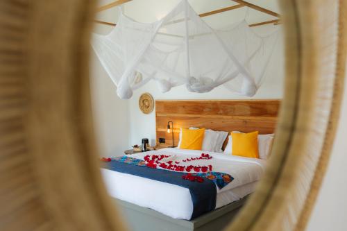 a bedroom with a large bed with red flowers on it at Tanzania Safari Lodge in Arusha