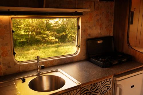 a kitchen with a sink and a window at Gezellig Chalet Ardennen The Secret View in Amblève