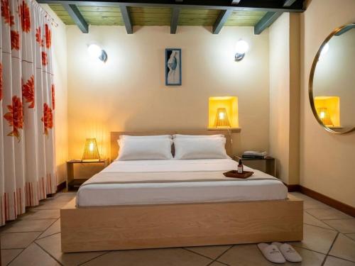 a bedroom with a large bed and a mirror at Casavacanze Salento Spani in Veglie