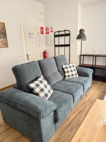 a blue couch sitting in a living room at Rincon de Toledillo in Plasencia