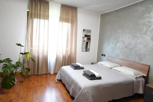 a bedroom with a bed with two towels on it at La CASA DI OLIVER in Pian Camuno